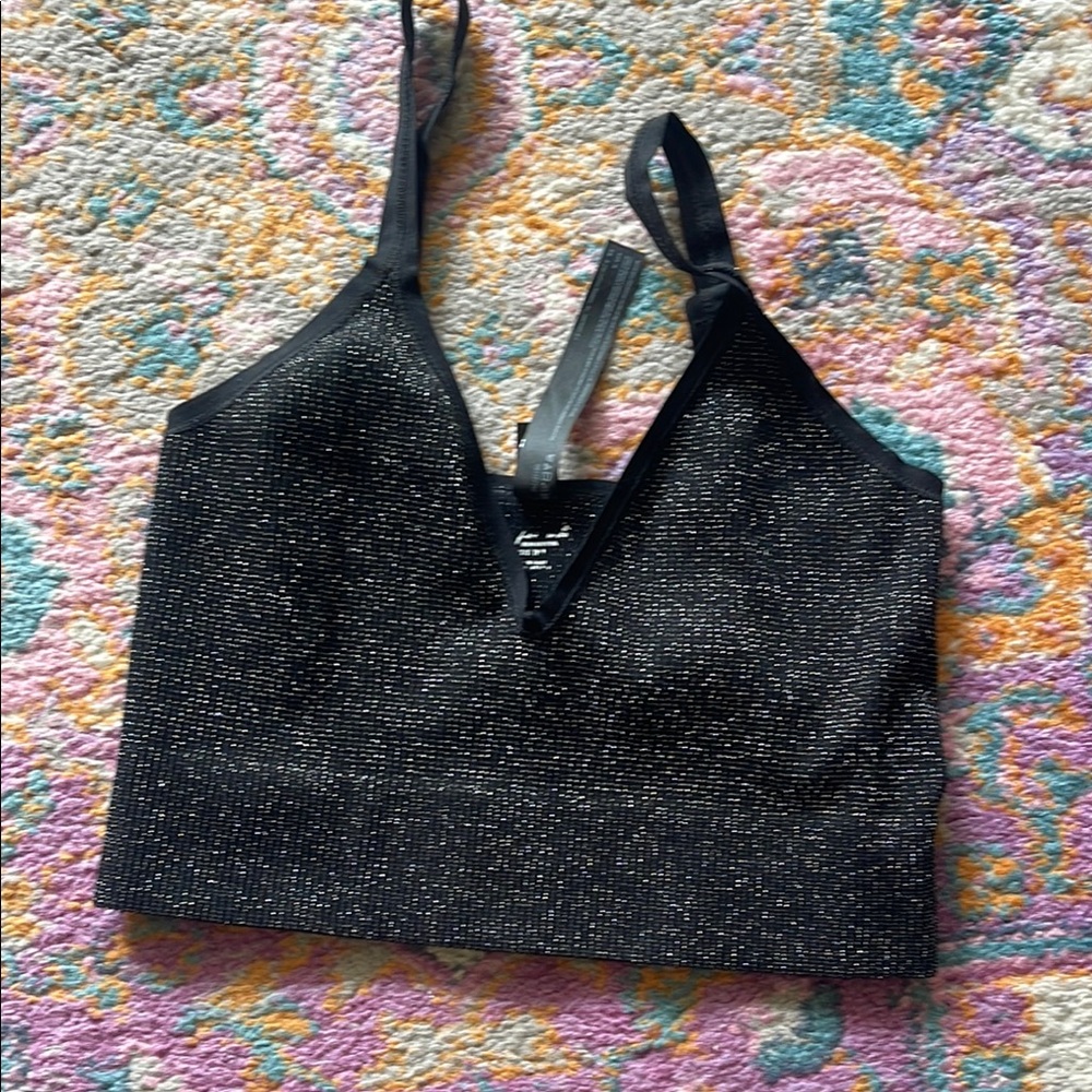 Out from under sparkly bra top with adjustable straps. Great condition size xs/s